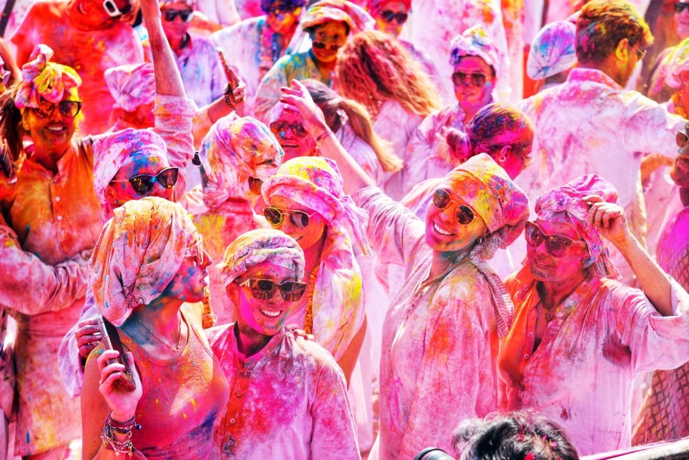 Jaipur: Foreign tourists smeared in colour celebrate Holi festival organised by the State Government's Tourism Department in Jaipur on Tuesday, March 07, 2023. (Photo: IANS/Ravishankar Vyas)