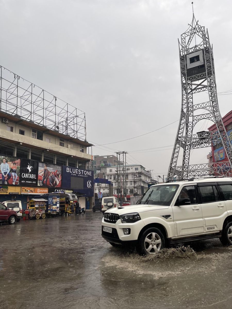 A vehicle passes through the water-logged City Clock Tower area, Dimapur on March 19. According to the IMD, Nagaland and other NE States are expected to experience heavy rainfall activity along with thunderstorm and gusty winds till March 21. (Morung Photo)