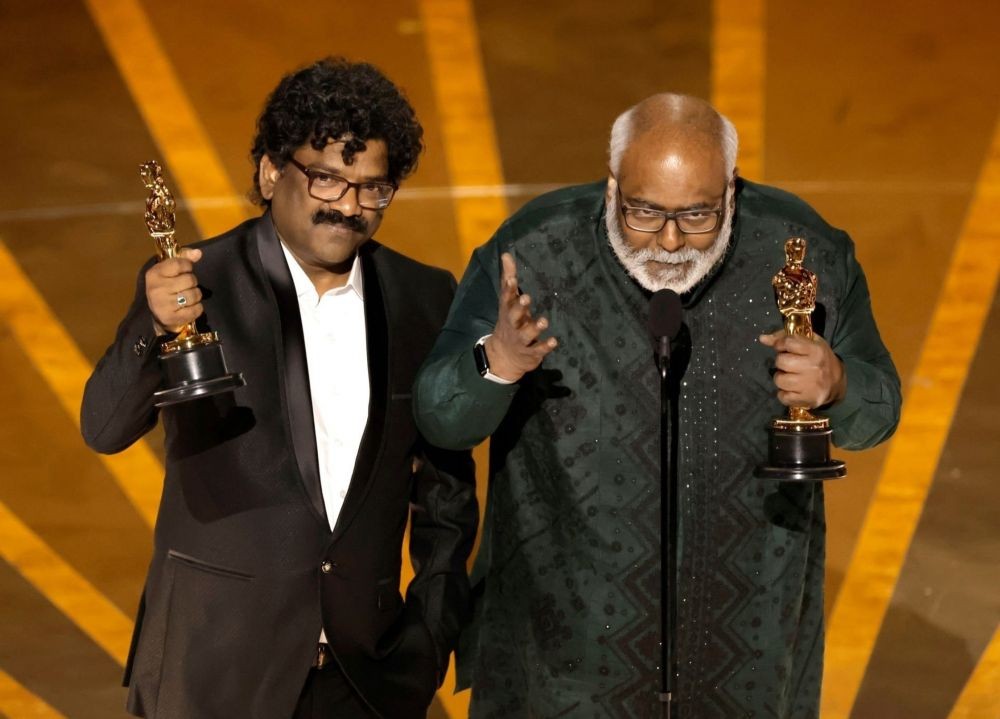 Los Angeles: Music composer M.M. Keeravani and lyricist Chandrabose accept the award for best original song for 'Naatu Naatu' from film 'RRR' at the Oscars 2023, in Los Angeles, USA on Sunday, March 12, 2023.  (Photo:IANS/Twitter)