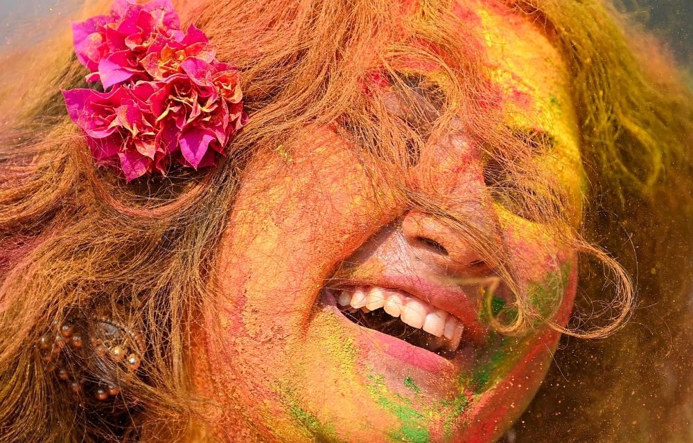Agartala: A woman smeared in colour celebrating Holi, in Agartala on Monday, March 06, 2023. (Photo:Abhisek Saha/IANS)