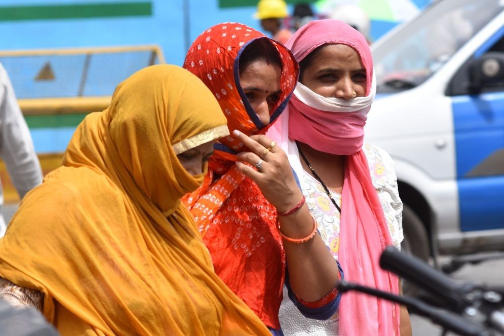 Women cover themselves to avoid scorching sun on a hot day in Jaipur, on June 8, 2018. (Photo: Ravi Shankar Vyas/IANS)