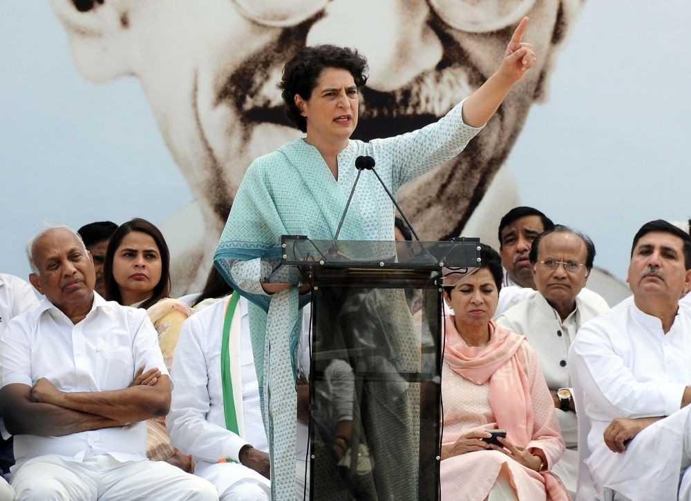 New Delhi: Congress General Secretary Priyanka Gandhi Vadra addresses during the party's 'Satyagraha' against the disqualification of Rahul Gandhi from Lok Sabha at Raj Ghat, in New Delhi on Sunday, March 26, 2023. (Photo:Qamar Sibtain/ IANS)