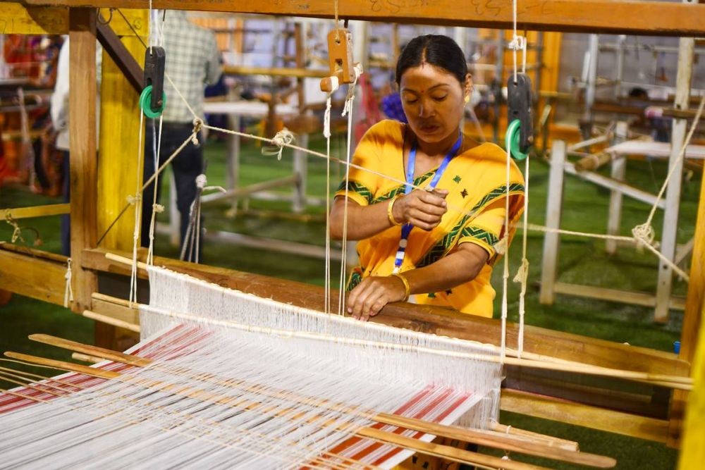 Guwahati :An Assamese woman busy weaving traditional 'gamosa' ahead of Rongali Bihu festival in Guwahati on Sunday, April 02, 2023. (Photo:IANS/Anuwar Hazarika)
