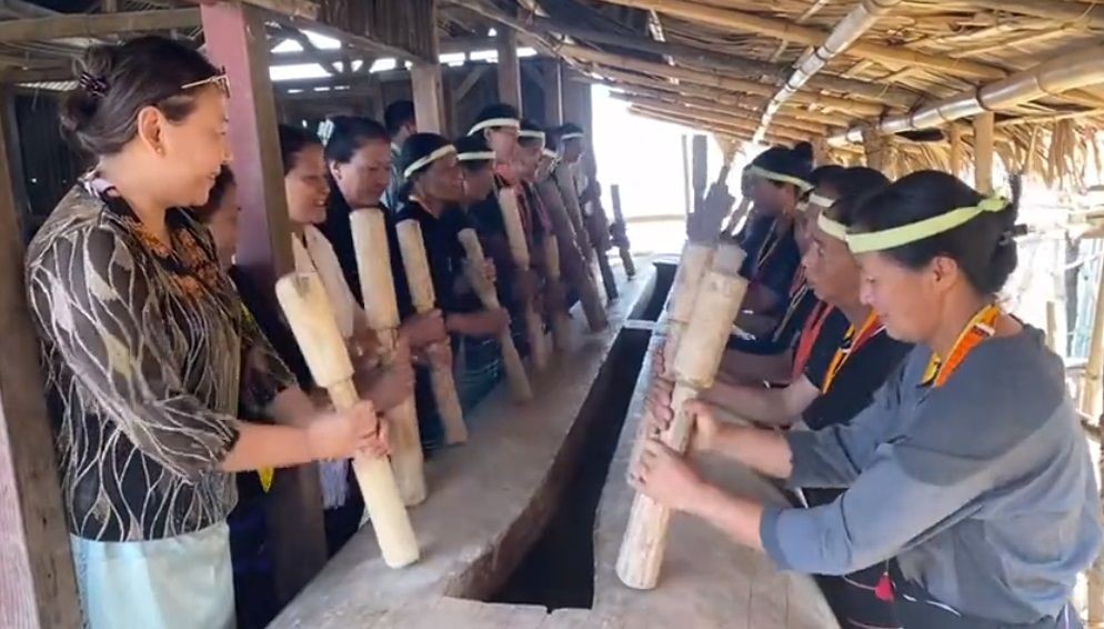 In this screengrab from a video, Nagaland’s Member of Parliament to Rajya Sabha, S Phangnon Konyak and other are seen participating in beating of the log drum for the first time by women at Wansoi village, under Noklak district on April 13. (Image Courtesy: @SPhangnon/Twitter).