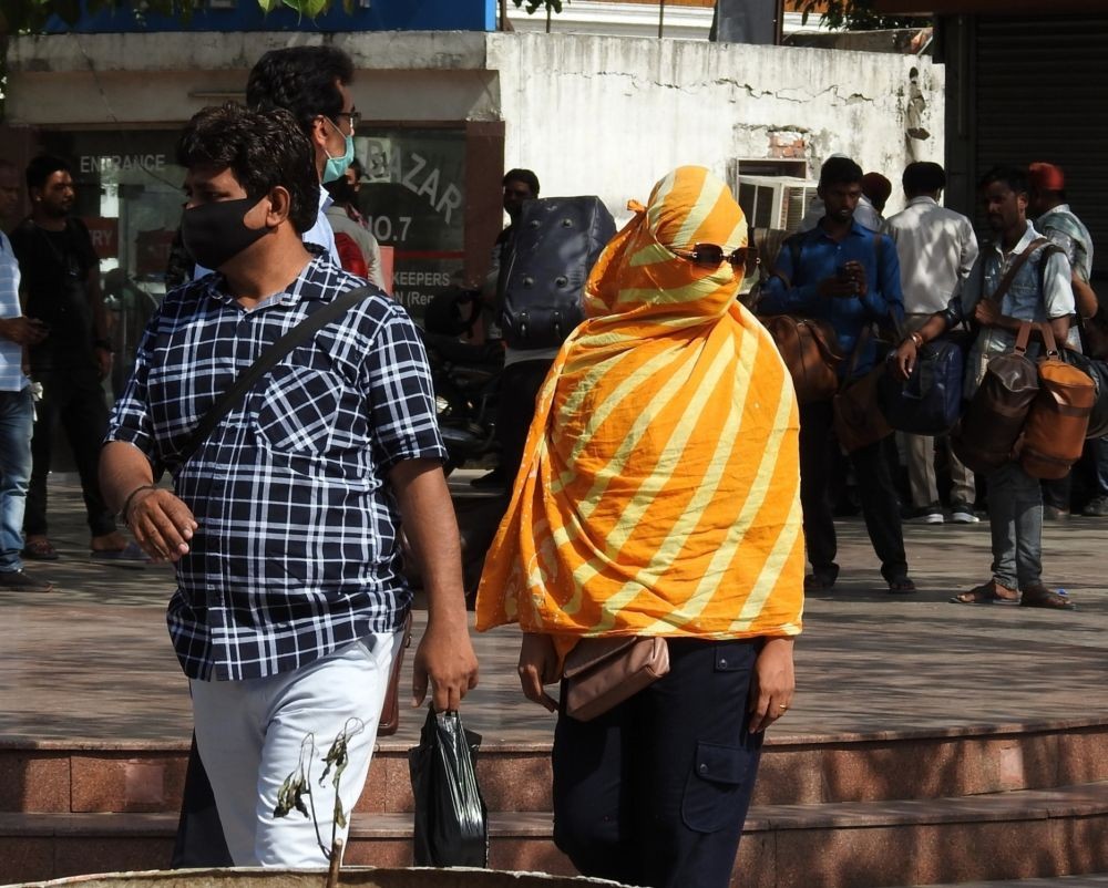 New Delhi: A woman covering her face with a piece of cloth tries to protect from the scorching sun on a hot day as the heatwave continues to hit the city, in New Delhi on Monday, June 06, 2022. (Photo: Anupam Gautam/IANS)