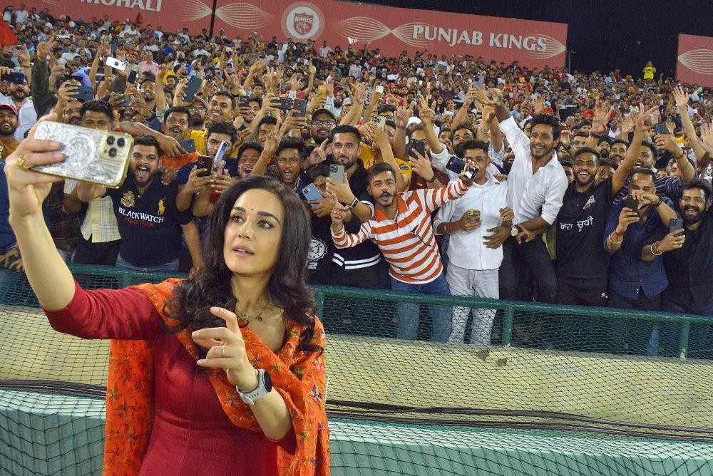 Mohali : Punjab Kings co-owner Preity Zinta takes a selfie with the fans during the IPL 2023 match between Punjab Kings and Gujarat Titans at Punjab Cricket Association Stadium in Mohali on Thursday, April 13, 2023. (Photo:IANS/Raj Kumar)