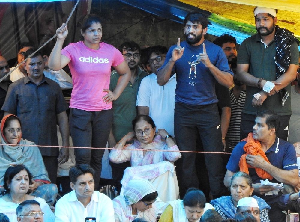 New Delhi: Wrestlers Sakshi Malik and Bajrang Punia speak during their protest at Jantar Mantar, in New Delhi on Thursday, May 04, 2023. (Photo: Anupam Gautam/ IANS)