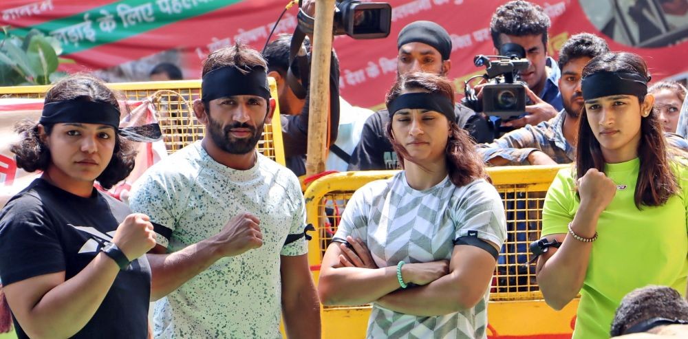 Wrestlers Bajrang Punia, Vinesh Phogat, Sangita Phogat and Sakshi Malik wear black bands during their ongoing protest against Wrestling Federation of India (WFI) chief Brij Bhushan Sharan Singh, at Jantar Mantar in New Delhi, Thursday, May 11, 2023.  (Photo: Wasim Sarvar/IANS)