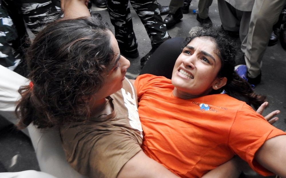 New Delhi: Wrestlers Vinesh Phogat and Sangita Phogat being detained by Delhi police during wrestlers' protest march towards new Parliament building, in New Delhi, Sunday, May 28, 2023. (Photo:IANS/Anupam Gautam)