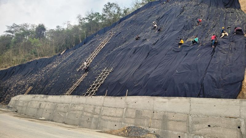 Road construction workers plant grass to control soil erosion along the two-lane road between Kohima-Phek districts. (Morung Photo)