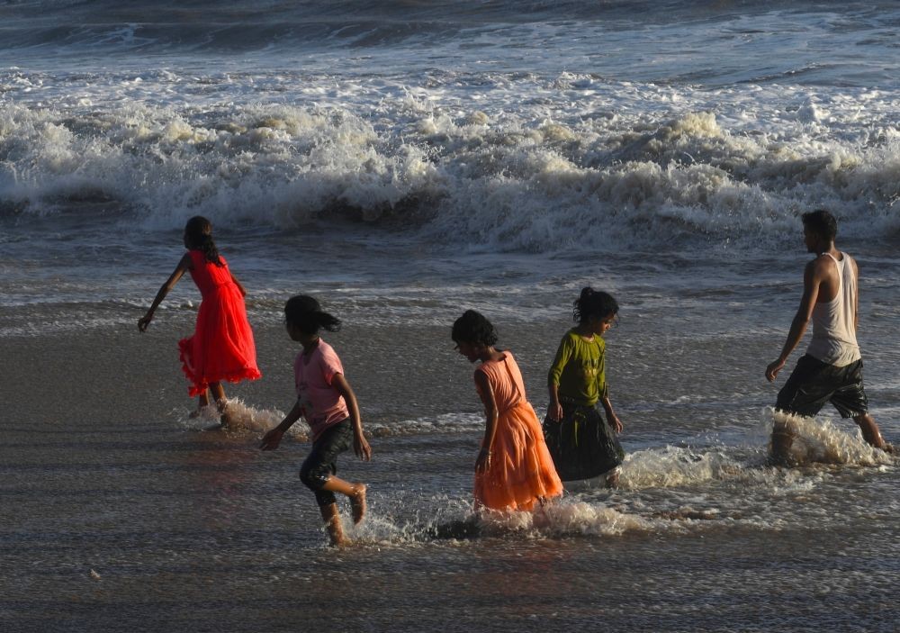 Mumbai : People enjoy high tide at Juhu Beach during sunset in Mumbai on Friday, June 09, 2023. (Photo: IANS)