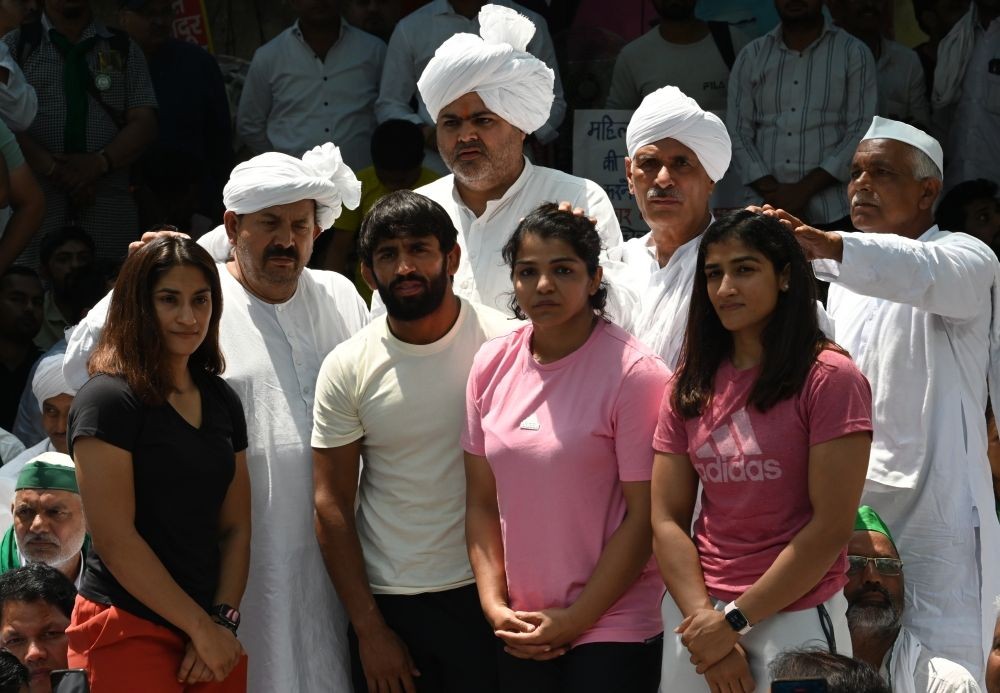 New Delhi: Farmer leader Naresh Tikait and other farmer leaders meet Wrestlers Bajrang Punia, Vinesh Phogat, Sakshi Malik during a protest at Jantar Mantar, in New Delhi, on Thursday, April 27, 2023.(Photo: Wasim Sarvar/IANS)