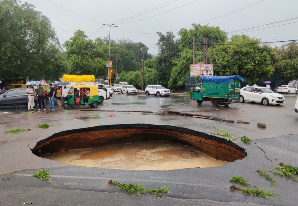 New Delhi: A crater is formed after a road caved in after heavy monsoon rains, at Rohini in New Delhi, Sunday, July 9, 2023.(IANS/Twitter:@Virend_Sachdeva)
