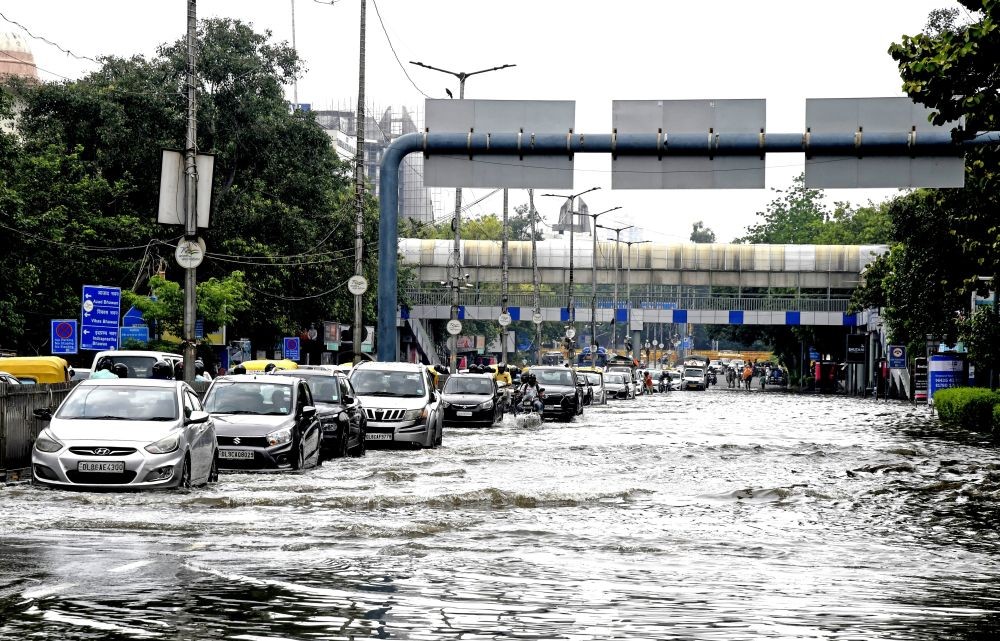 New Delhi: Vehicles wade through a waterlogged road at ITO as floodwater continues to recede, in New Delhi, on Sunday, July 16, 2023. (Photo: IANS)