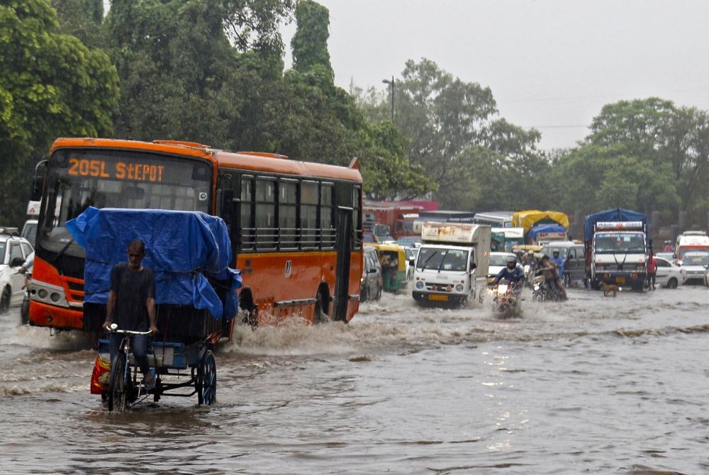 New Delhi: Vehicles move through a waterlogged road after heavy rainfall near Nigambodh Ghat in New Delhi on Saturday, July 8, 2023. (Photo: IANS/Wasim Sarvar)