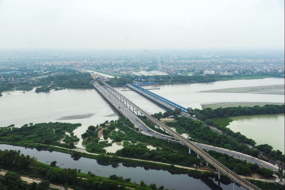 Noida : An aerial view of Noida reveals decreased water levels of the swollen Yamuna river after recent monsoon rainfall, on Saturday, July 15, 2023. (Photo:IANS)