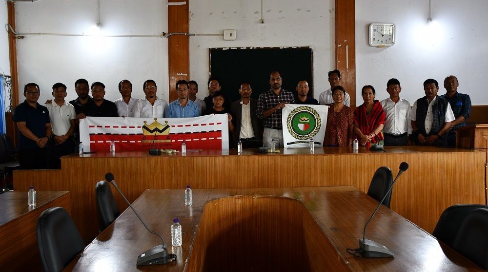 The Wokha DC and other dignitaries unveiling the official flag of the WDCA on July 22. (DIPR Photo)