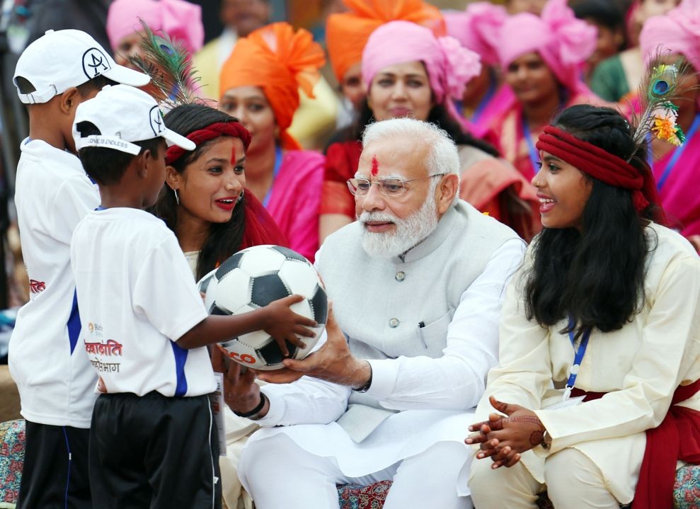 Shahdol: Prime Minister Narendra Modi during an interaction with tribal leaders, PESA committe members, Lakhpati didis from SHGs and football players, at Pakaria village in Shahdol district, on Saturday, July 01, 2023. (Photo:IANS/PIB)