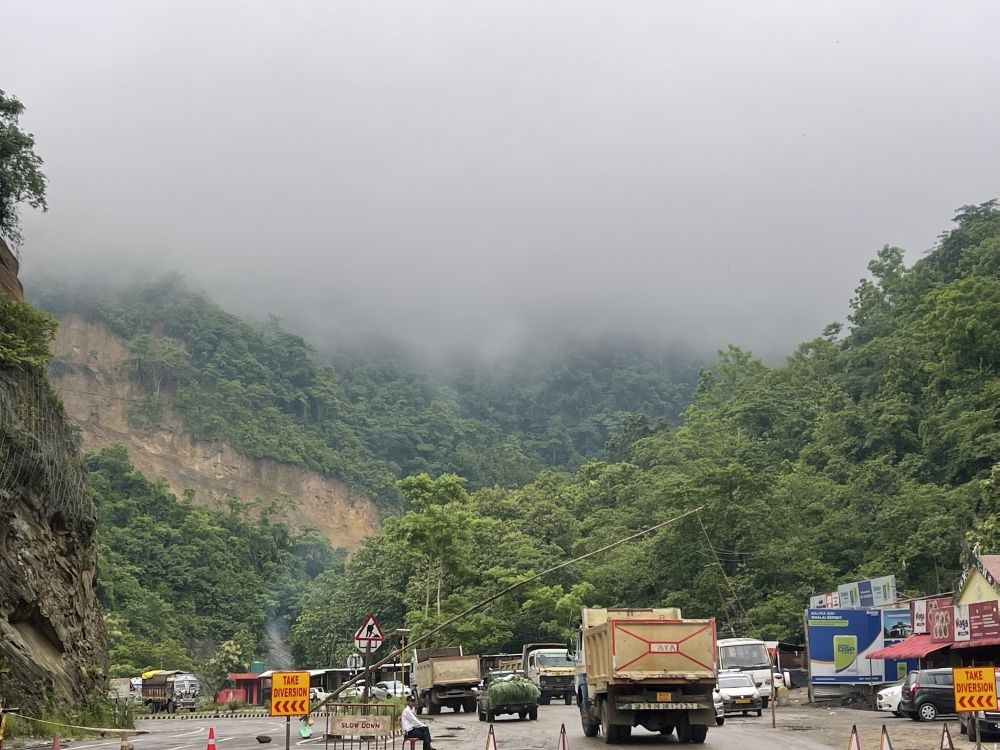 Heavy vehicles pass through the temporary check-post set up after the July 4 rock slide incident on the NH-29 Chümoukedima stretch on July 17. (Morung Photo)