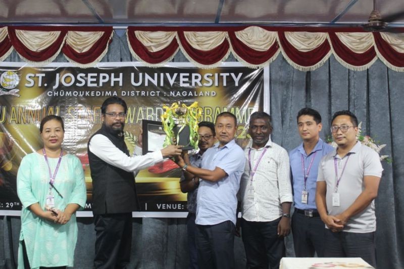 An award being presented to one of the faculty and staff members at St Joseph University.