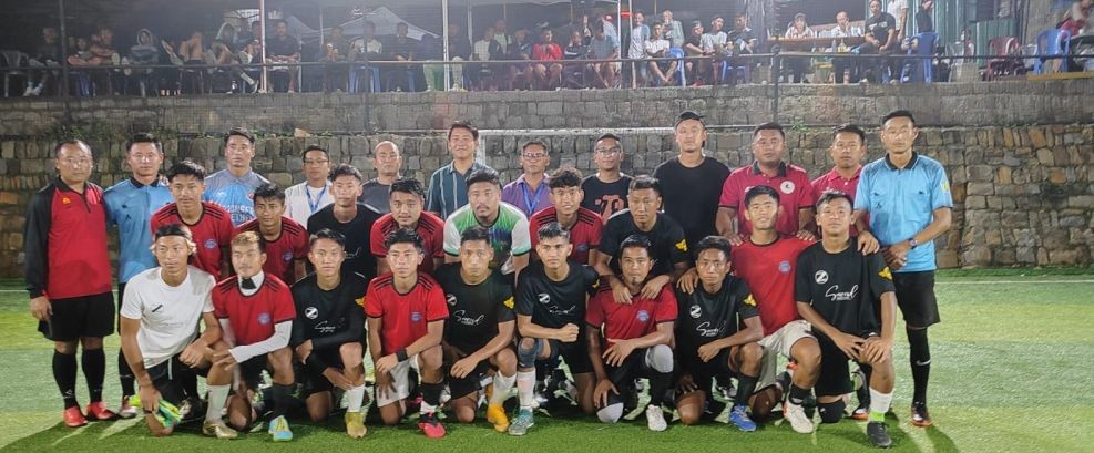 Players of Zasivi FC (black) and Red Scars (A) before the final match at Kohima on Saturday evening.