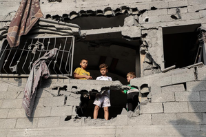 Palestinian boys stand in a damaged building after Israeli airstrikes in the Southern Gaza Strip city of Khan Younis, Oct. 25, 2023. The death toll of Palestinians from Israeli airstrikes on the Gaza Strip has risen to 6,546, the Hamas-run Health Ministry said on Wednesday. (Photo by Rizek Abdeljawad/Xinhua/IANS)
