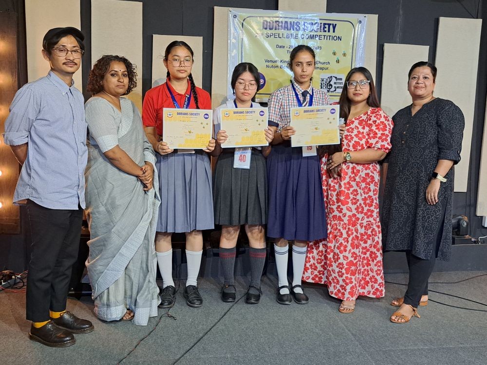 Winner of the 2nd Dorians Society Spell Bee Competition— Likyaro Patton (centre) flanked by the first and second runners-up, Shahnaz Ali and Kowsara Begum seen with the judges and pronouncers/moderators at the Kingdom Culture Church, Dimapur on October 28. (Morung Photo)