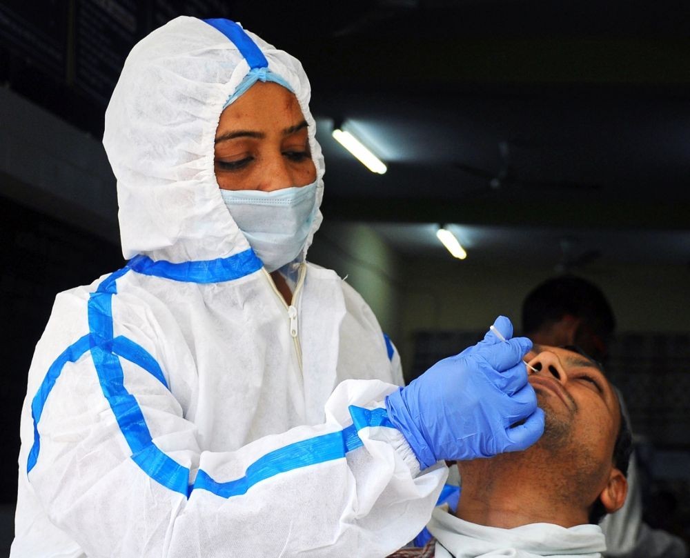 New Delhi: A healthcare worker collects a swab sample of a man for Covid-19 test, amid a sudden spurt in COVID 19 cases, in New Delhi, on Thursday, April 13, 2023.(Photo: Qamar Sibtain/IANS)