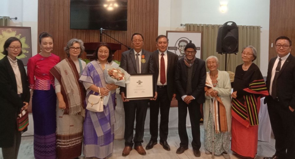 Rev Yanger Walling (with certificate), his wife Zarchala (with bouquet) alongwith Navojyoti Datta (fourth from right) and Rev Bonny Resu (fifth from right) and members of the Kevichusa family at the award ceremony on December 21. (Morung Photo)