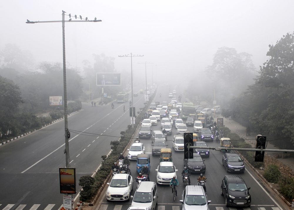 New Delhi: Vehicles ply on road amid dense fog on cold winter morning in New Delhi,Tuesday , Jan 16, 2024.(IANS/Wasim Sarvar)