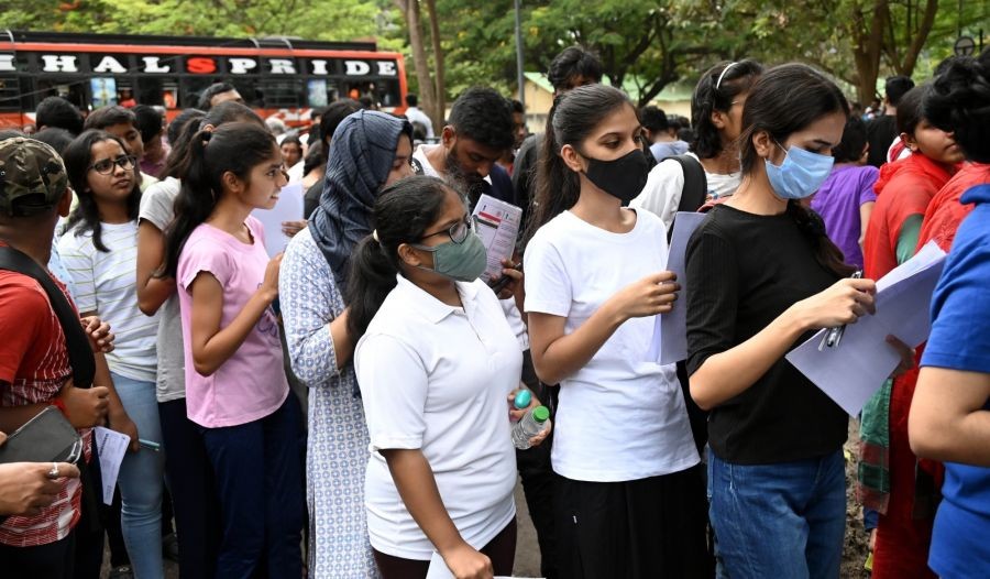 Students wait outside before entering the examination centre to appear in the NEET-UG exam, in Bengaluru, on Sunday, May 7, 2023. (Photo: Dhananjay Yadav/IANS)