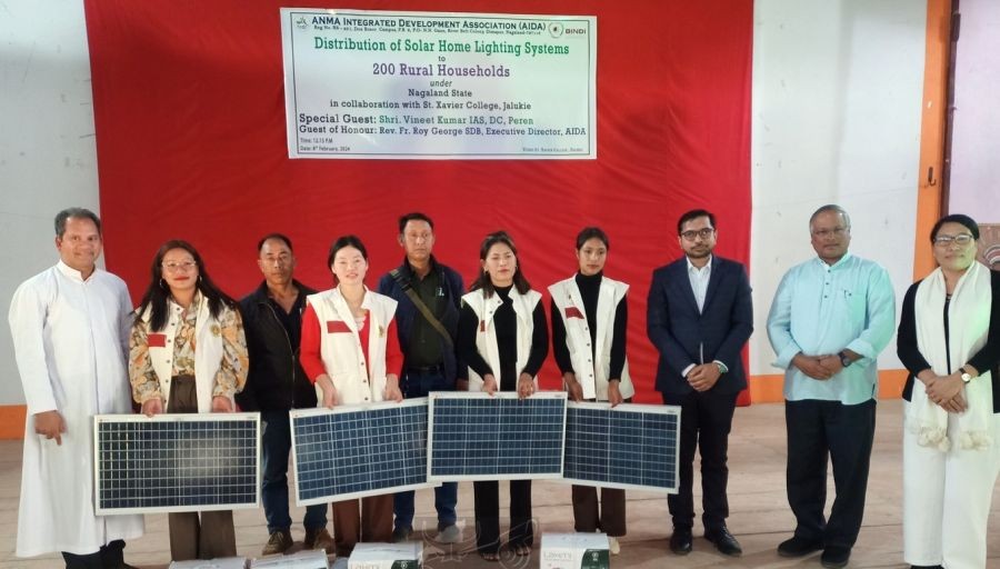 Village representative along with the official during the home lighting system distribution at St Xavier College Jalukie held on February 8. (DIPR Photo)