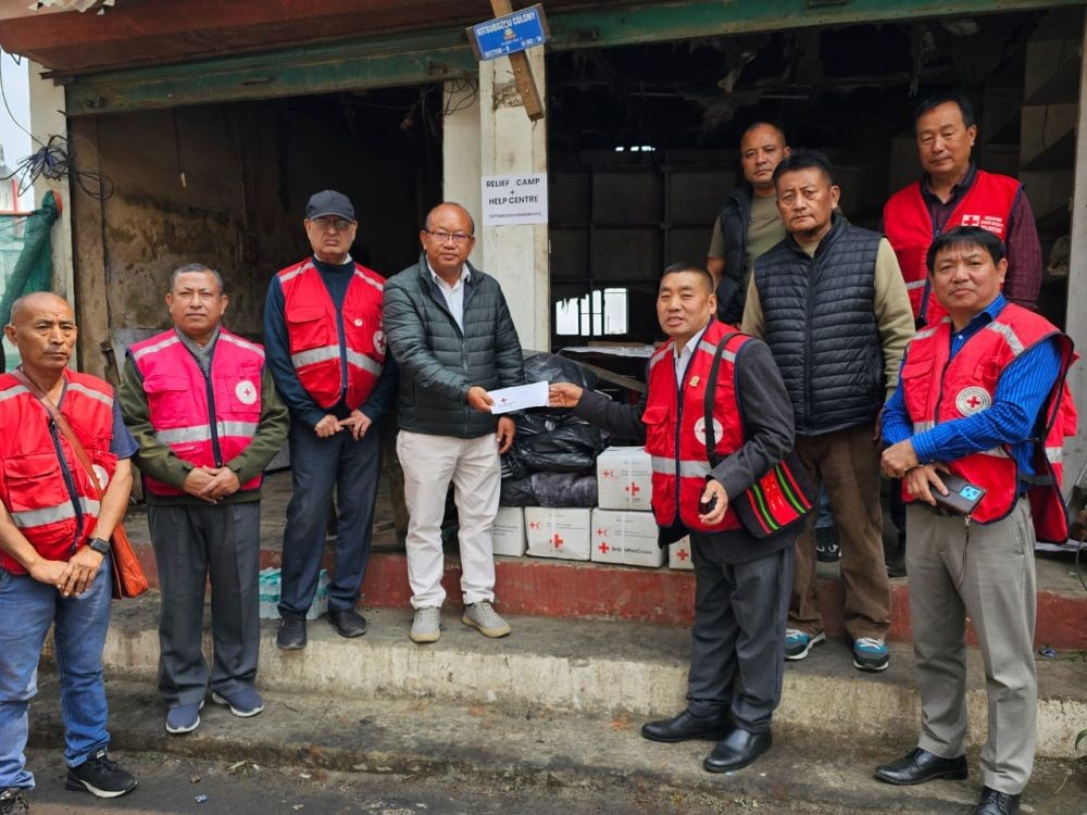 The Indian Red Cross Society (IRCS), Kohima District Branch handing relief materials and monetary assistance to the fire victims of Kitsubozou, Kohima . The items were received by the Chairman, Kitsubozou on behalf of the victims on March 20.