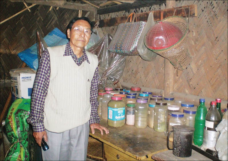 N. Imti Ao (NCS. Retd) displays the herbal plant items all stored in containers and kept intact before final production. (Morung Photos)