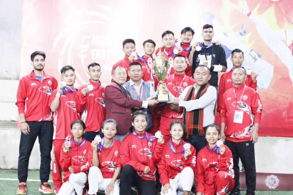 Nagaland taekwondo team lifting the overall group champion trophy at Chumoukedima on Friday.