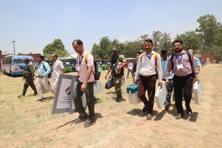 Polling officials carry Electronic Voting Machines (EVMs) and other election-related materials as they leave from the distribution center to their respective polling booths ahead of the last and seventh phase of the Lok Sabha elections, in Chandigarh on Friday, May 31, 2024. (Photo: IANS/Ajay Jalandhari)