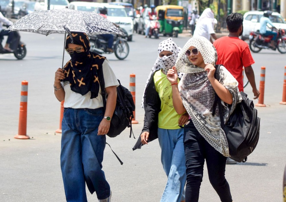 Lucknow: Commuters walk past amid scorching heat on a hot summer day in Lucknow on Wednesday, May 29, 2024. (Photo: IANS/Phool Chandra)