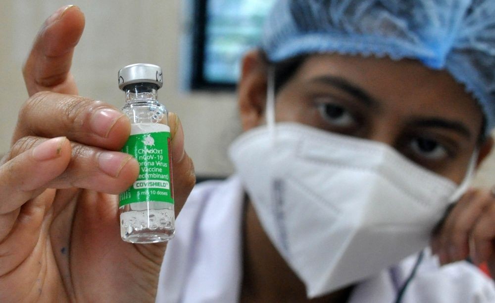 Kolkata:A health worker shows a vial of Covishield vaccine before administering the same to an elderly man at a government hospital in Kolkata on Monday,Jan.10,2022.(Photo: Kuntal Chakrabarty/IANS)