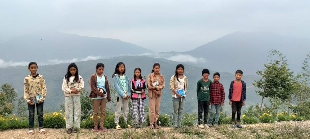 Sunday school students on their way to attend church pose for a picture at Woilan Kingphu village under Myanmar on May 19. (Morung Photo)
