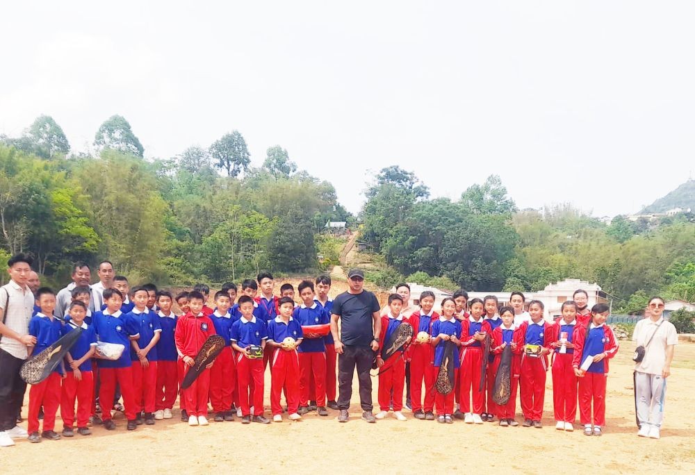 Libemo Jami, District Youth Resources Officer along with the students of Don Bosco School in Riphyim village, Wokha District after distributing the Sports kits.