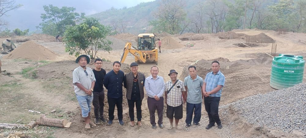 The team during the joint site visit for review of the ongoing work of Prefab Multipurpose Hall at Kezo Town.