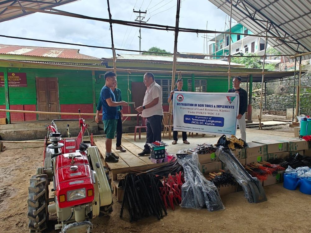 DC Kiphire Temsuwati Longkumer handing over power tiller key to progressive farmer at Hopongkyu Memorial Hall in Kiphire town.