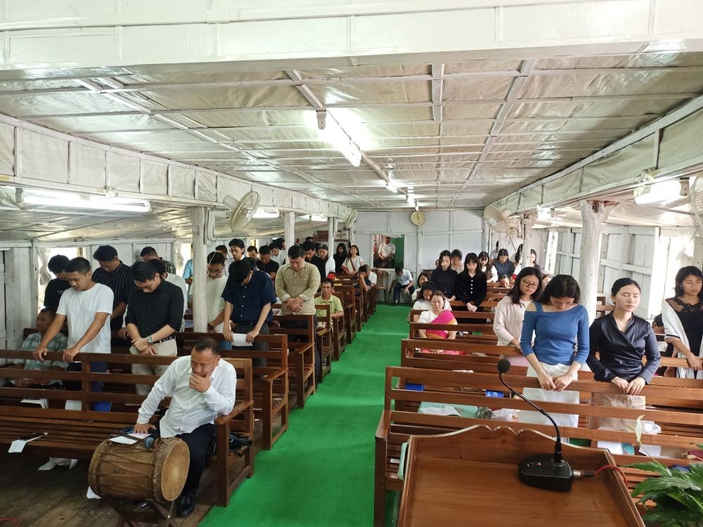 Youths of Kohima Liangmai Baptist Church youth department stand during a blessing prayer by Pastor Rev N Silubo Zeliang  on the occasion of its 21st Youth Foundation Day.(Photo Courtesy: KLBC)