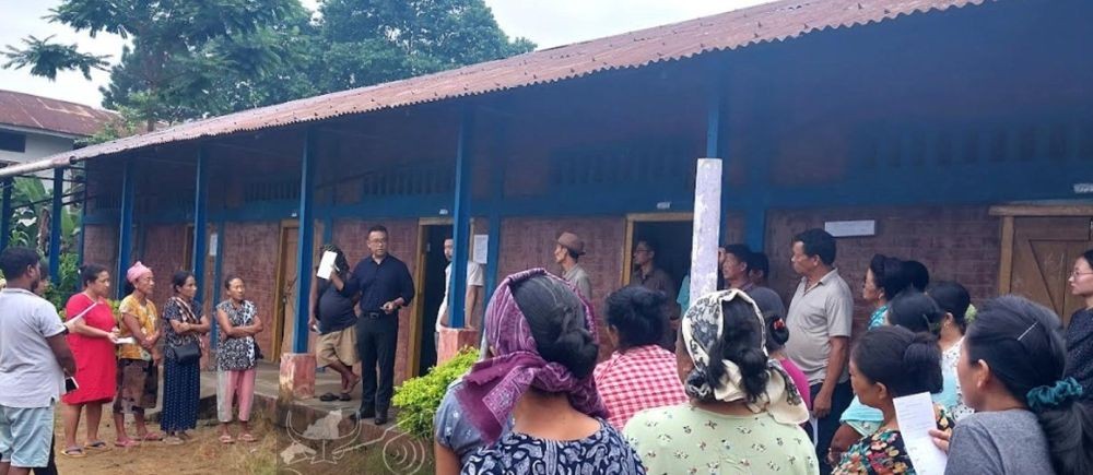 EAC & Sector Magistrate, Mangkolemba, N Orenthung Kikon illustrating to voters the proper way to use a ballot paper at GPS Mangkolemba on June 20. (DIPR Photo)