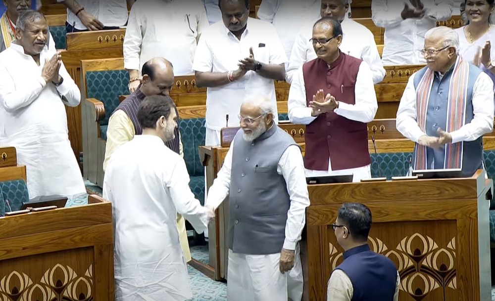 New Delhi: LoP Rahul Gandhi greets Prime Minister Narendra Modi after BJP MP Om Birla elected as the Speaker of the 18th Lok Sabha at Parliament House on Wednesday, June 26, 2024. (Photo: IANS/Sansad TV)