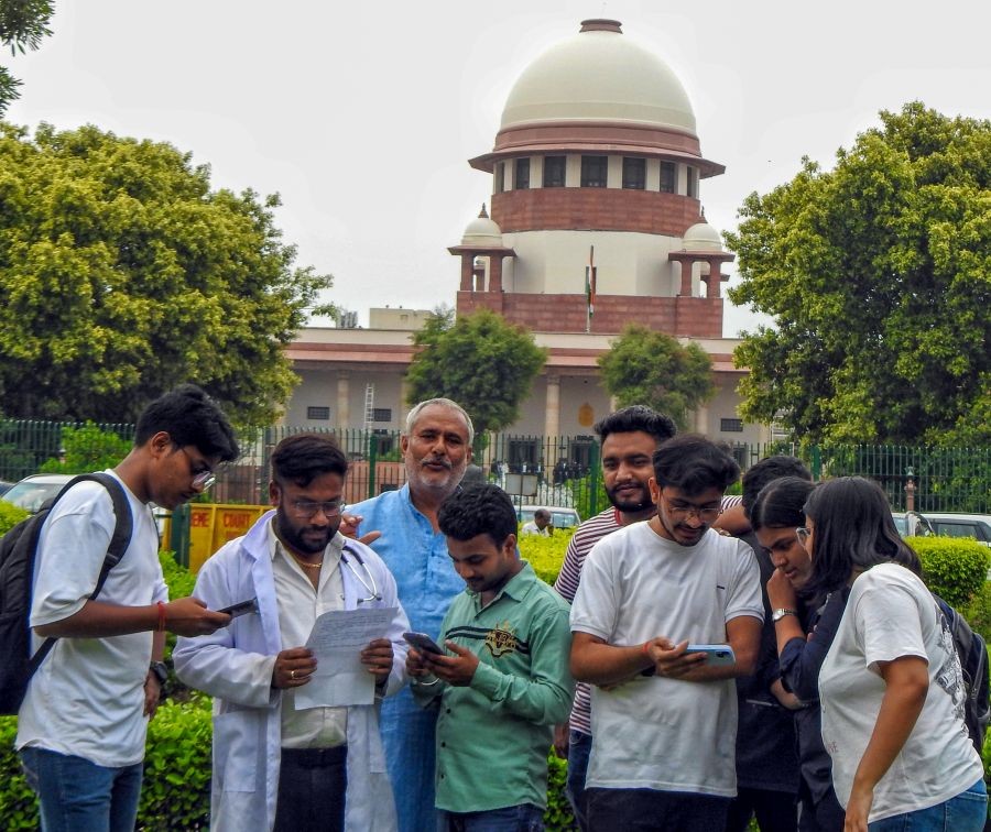 Students seen outside the Supreme Court during the hearing of the alleged NEET paper leak case in New Delhi on Thursday July 18,2024. (Photo: IANS/Anupam Gautam)