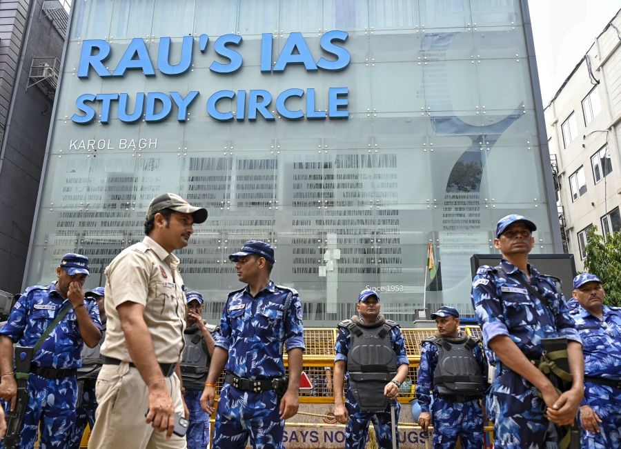 Rapid Action Force (RAF) and police personnel stand guard outside the 'Rao IAS Study Centre' during a students' protest after three civil service aspirants died due to flooding in the basement of the coaching centre, at Old Rajinder Nagar in New Delhi on Sunday, July 29, 2024.(IANS/Wasim Sarvar)