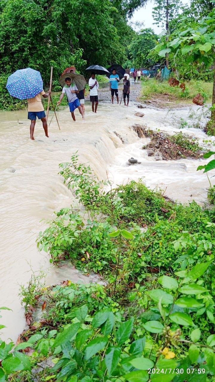 Villagers cross a flooded road somewhere in Ralan area under Bhandari Sub Division of Wokha district. Flash floods due to incessant rain since 29 July has resulted in extensive damages to crops and properties in Ronsayan and Jandalashung B villages under the division.