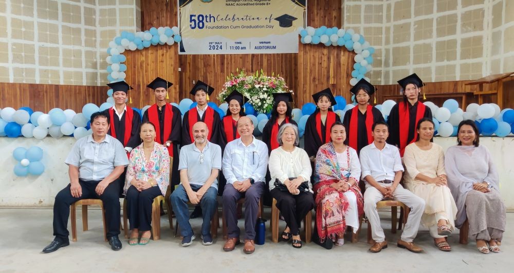 Graduating students with faculty and other dignitaries.