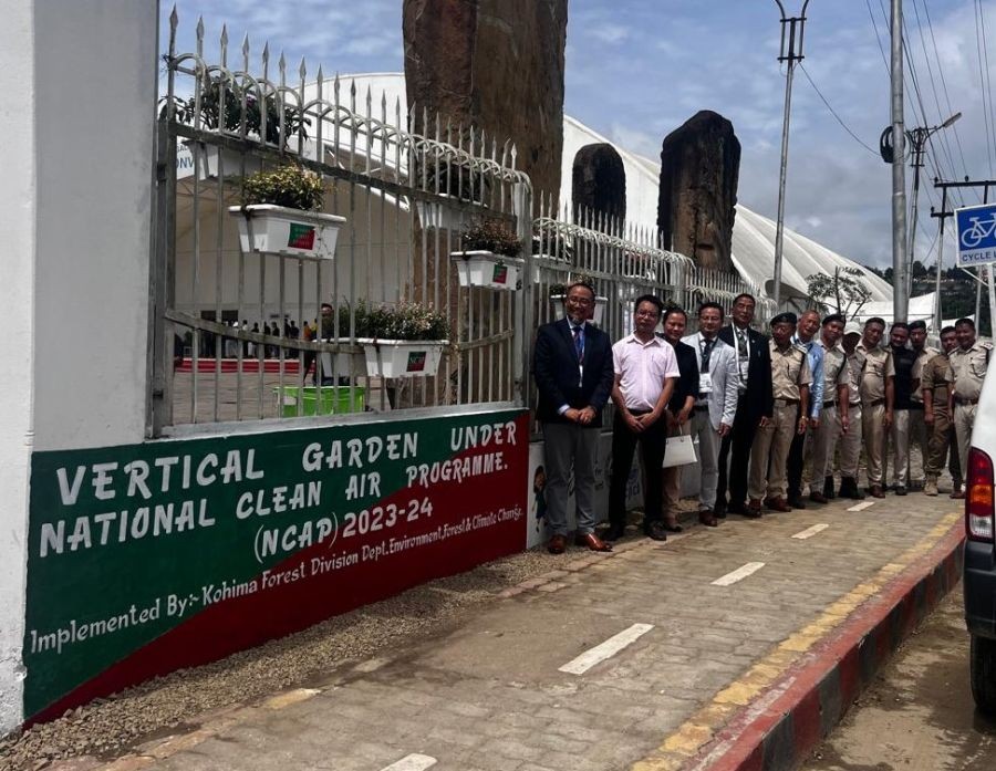 Officials pose along the newly inaugurated vertical garden in Kohima.